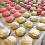 a table full of icing cookies